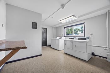 A white reception area with a desk and a window.